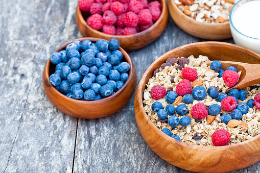 berries, nuts and oats in bowls