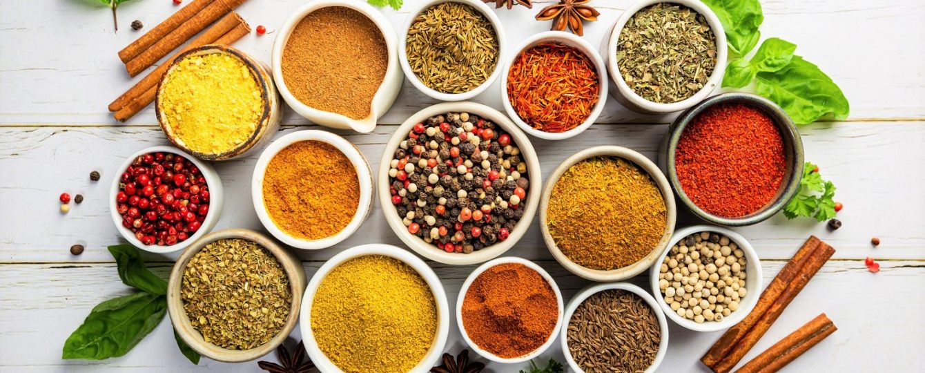 Colorful assortment of herbs and spices in bowls